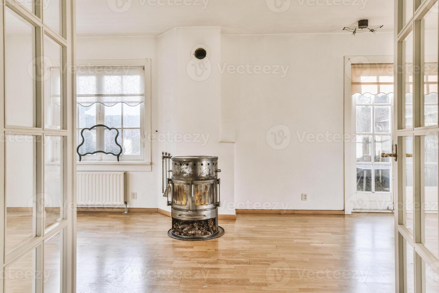 A room with a fireplace and wooden floors photo