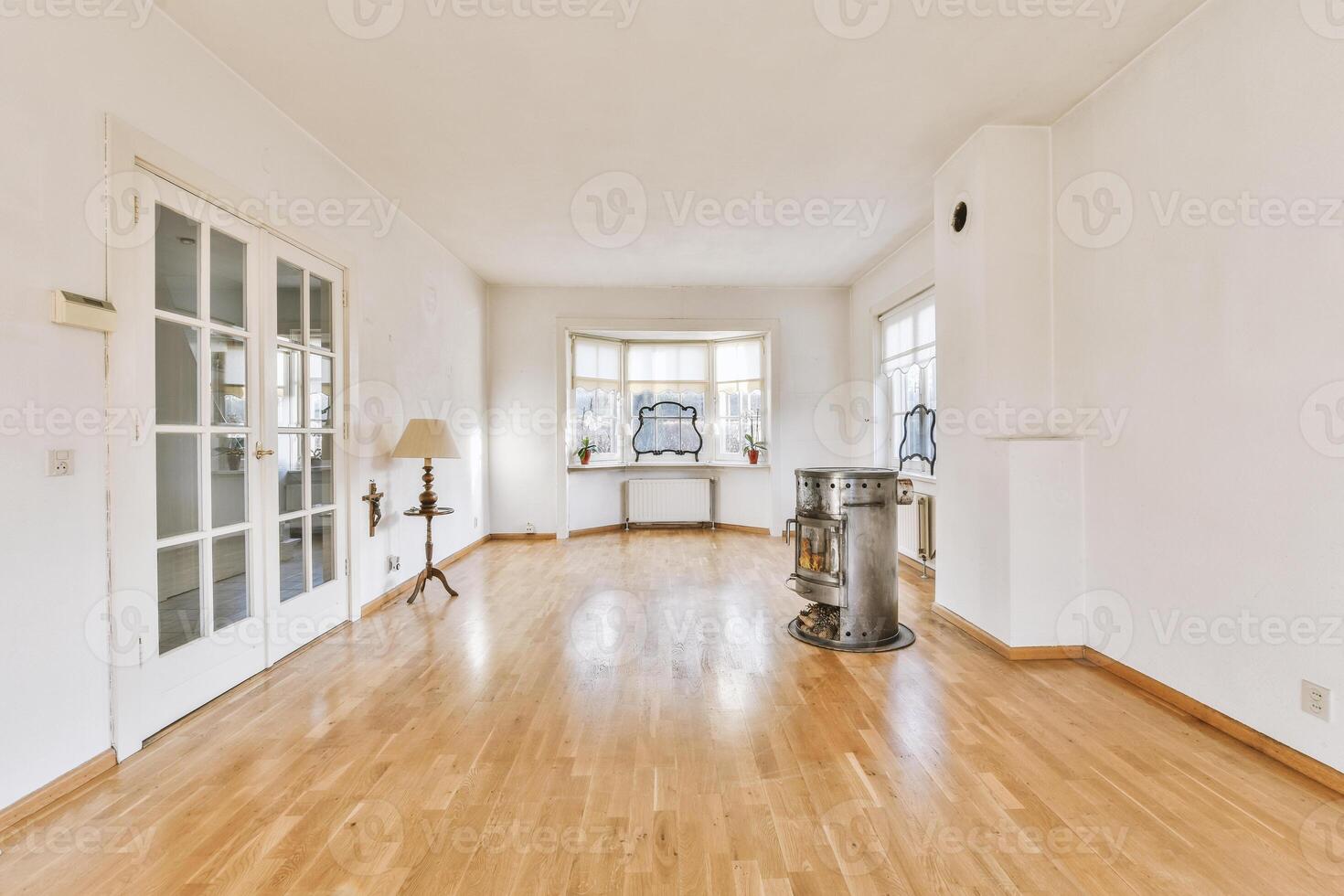 A room with wooden floors and white walls photo
