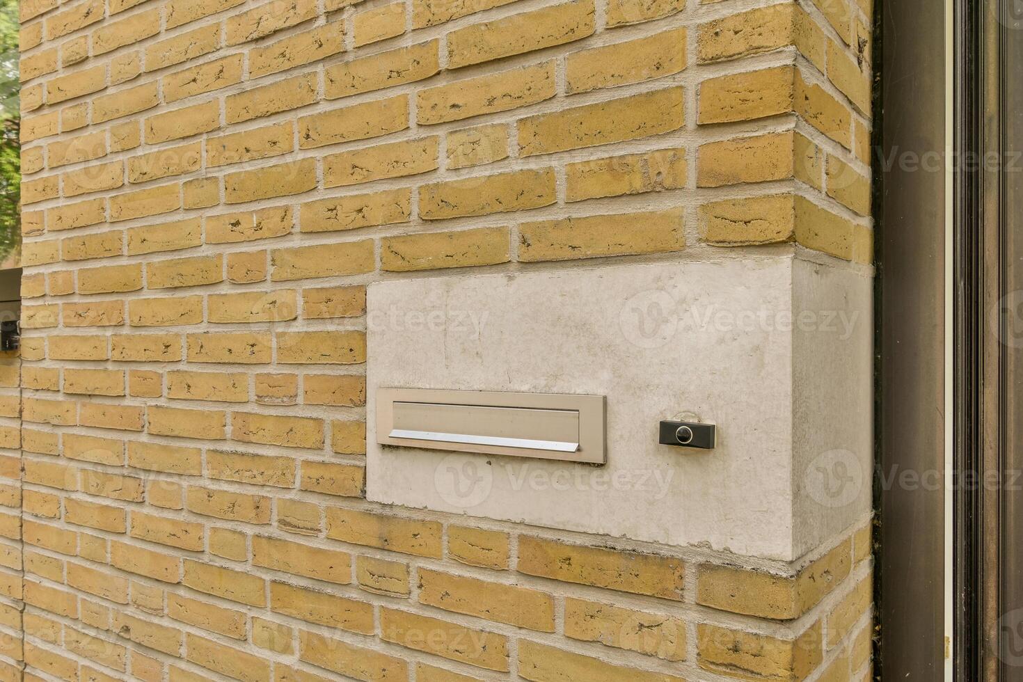A brick wall with a mailbox on it photo