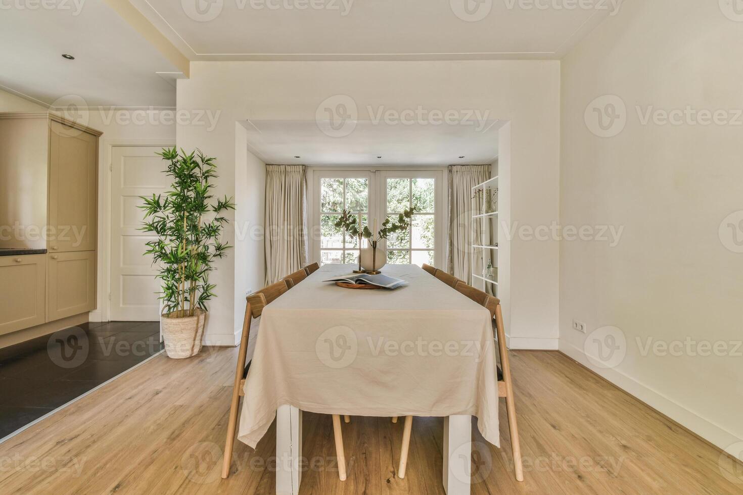 A dining room with a table and chairs photo