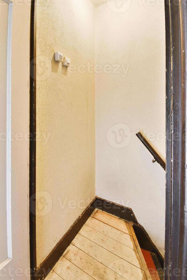 A hallway with a wooden floor and a door photo