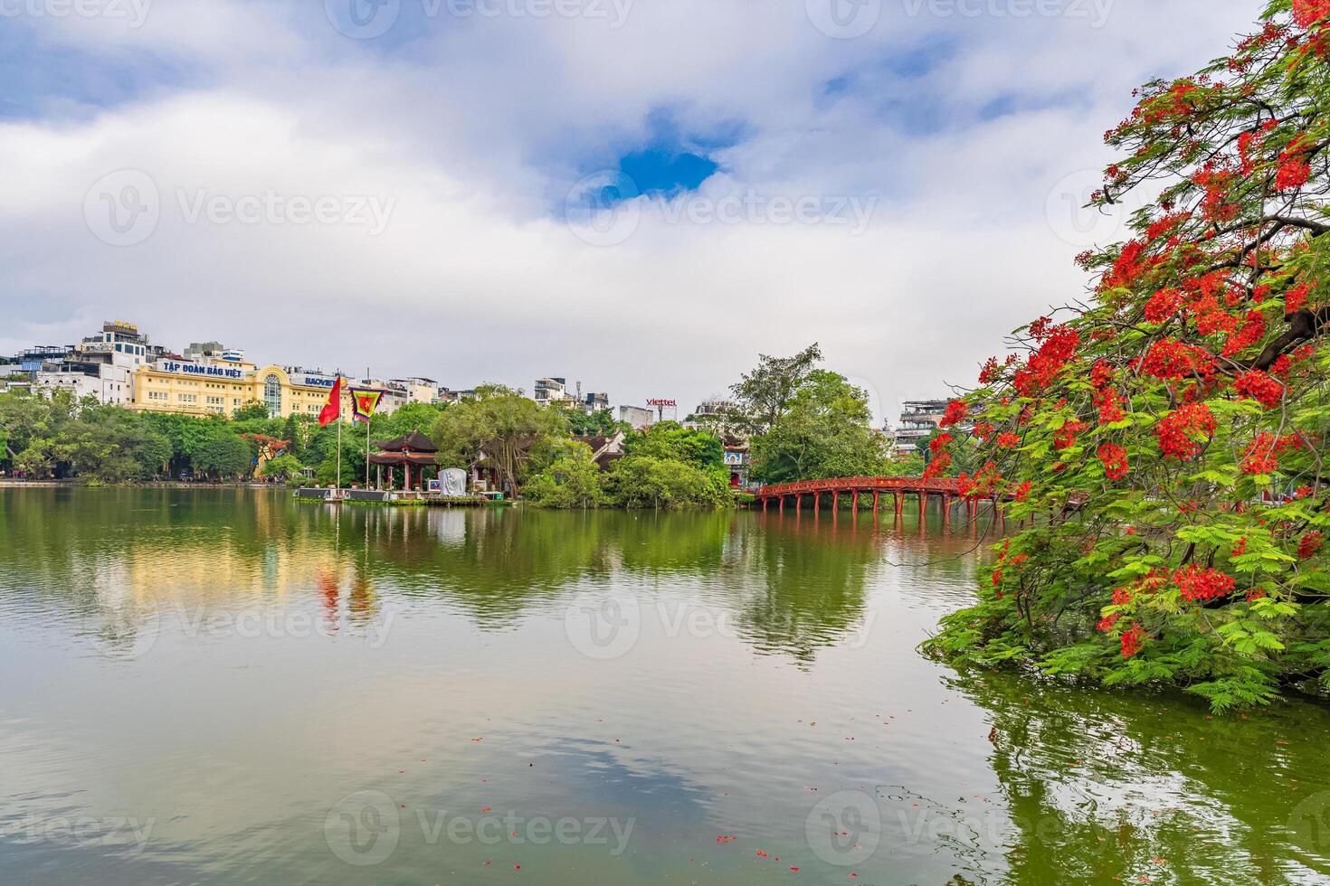 Hanoi, Vietnam - 26 June 2024 Red The Huc Bridge and Ngoc Son Temple in the center of Hoan Kiem Lake, Hanoi, Vietnam. Famous destination of Vietnam photo
