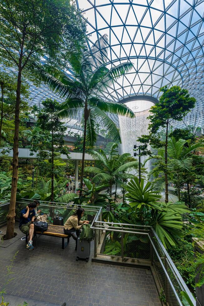 Singapore - Jun 13 2024 The Rain Vortex, a 40m-tall indoor waterfall located inside the Jewal Changi Airport in Singapore. Travel concept photo