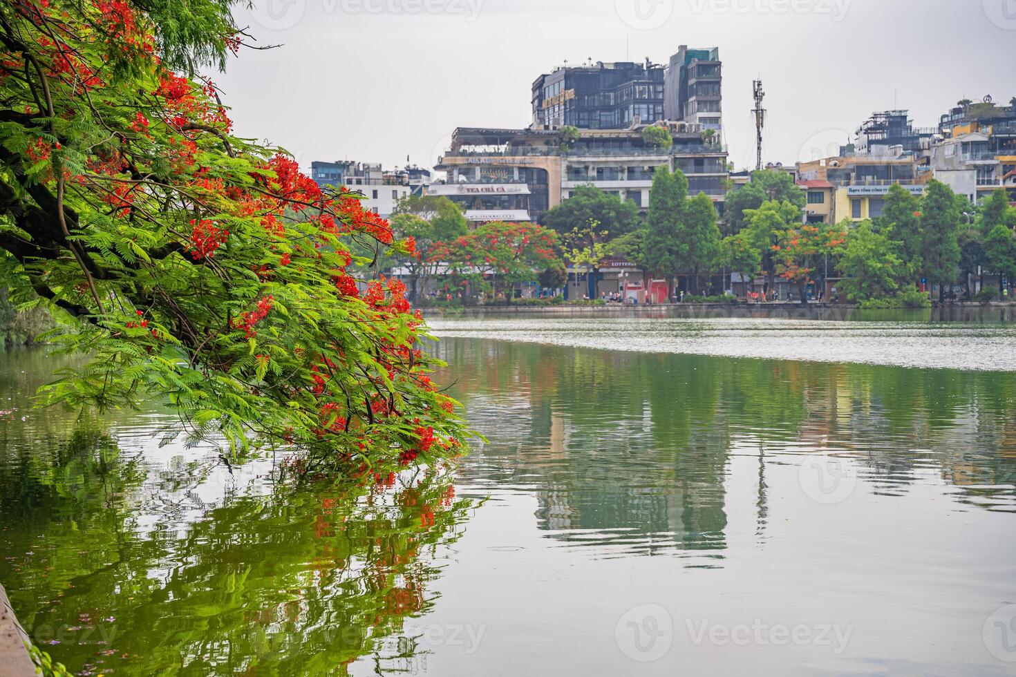 Hanoi, Vietnam - 26 June 2024 Hoan Kiem lake or Sword lake, Ho Guom in Hanoi, Vietnam with Turtle Tower, on clear day with blue sky and white clouds photo