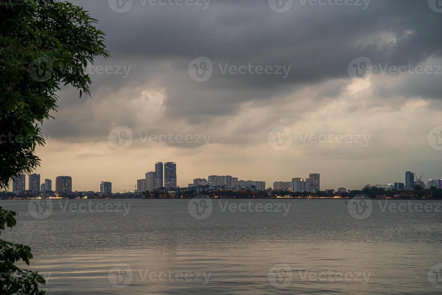 Hanoi, Vietnam - 25 Jun 2024 West Lake in Hanoi in the dark cloudy evening. Ha Noi cityscape. Travel concept photo