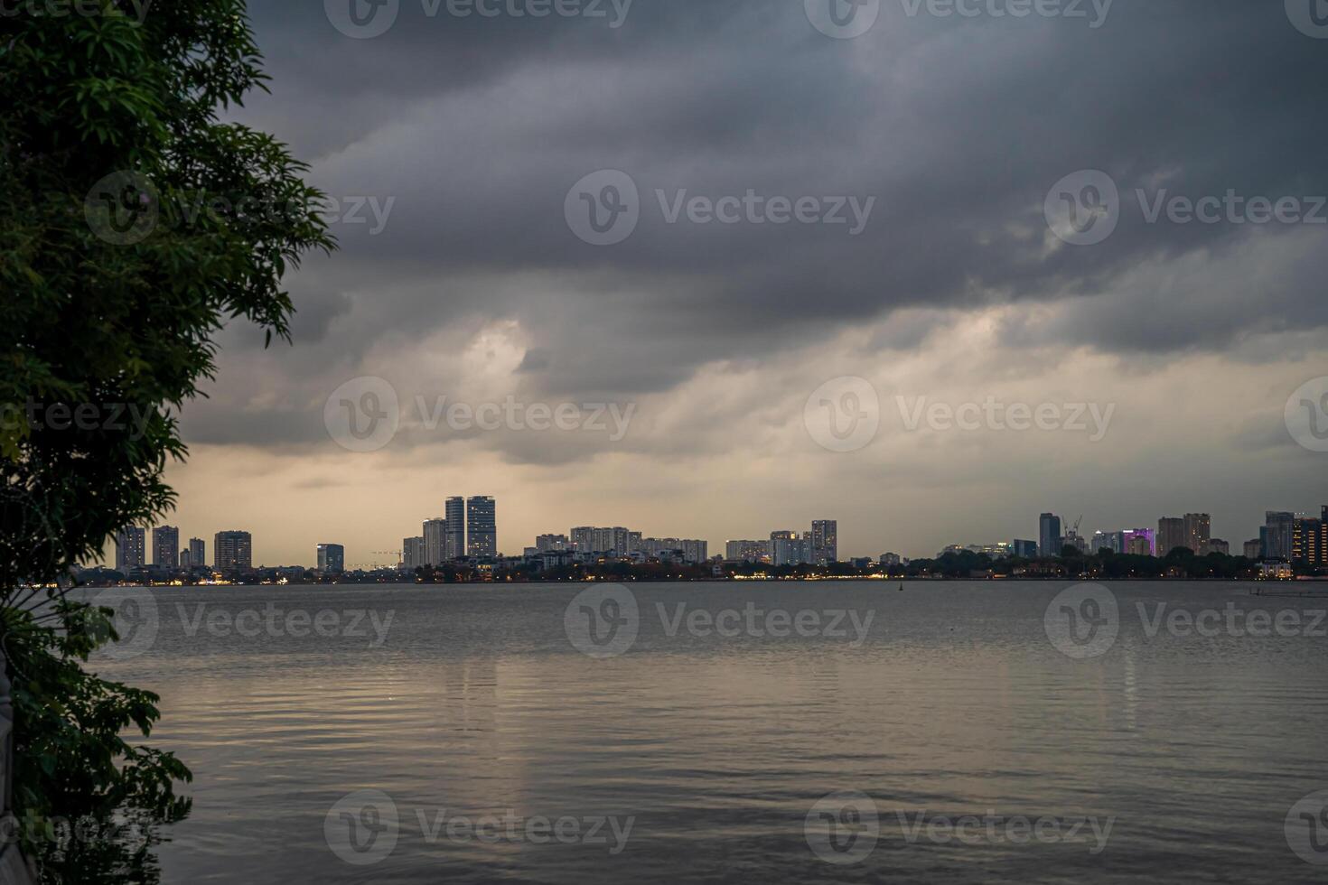Hanoi, Vietnam - 25 Jun 2024 West Lake in Hanoi in the dark cloudy evening. Ha Noi cityscape. Travel concept photo