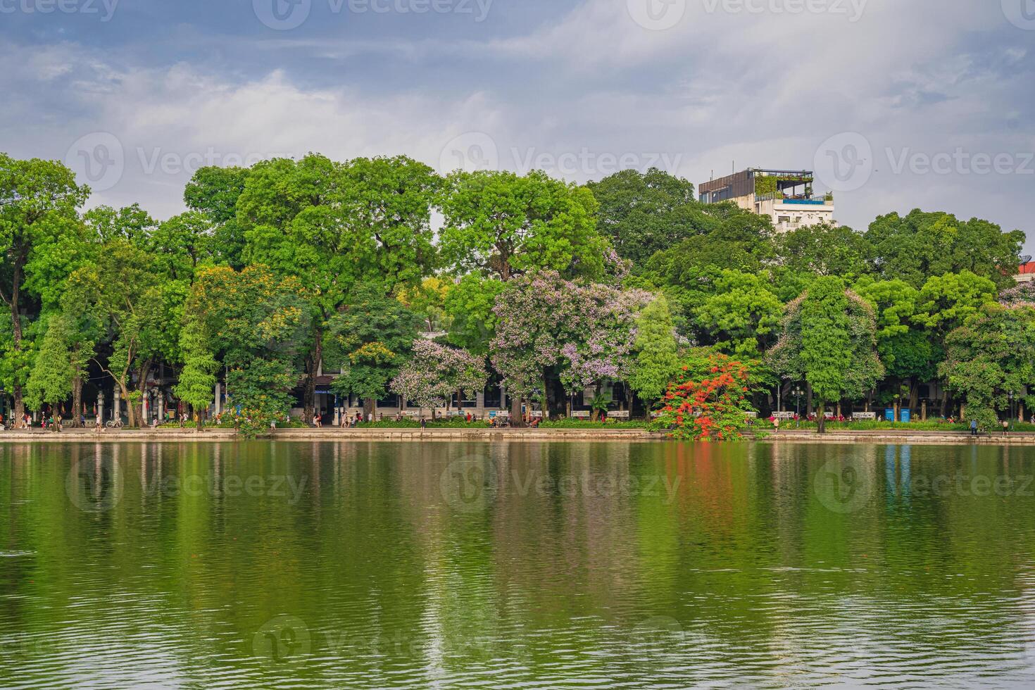Hanoi, Vietnam - 26 June 2024 Hoan Kiem lake or Sword lake, Ho Guom in Hanoi, Vietnam with Turtle Tower, on clear day with blue sky and white clouds photo