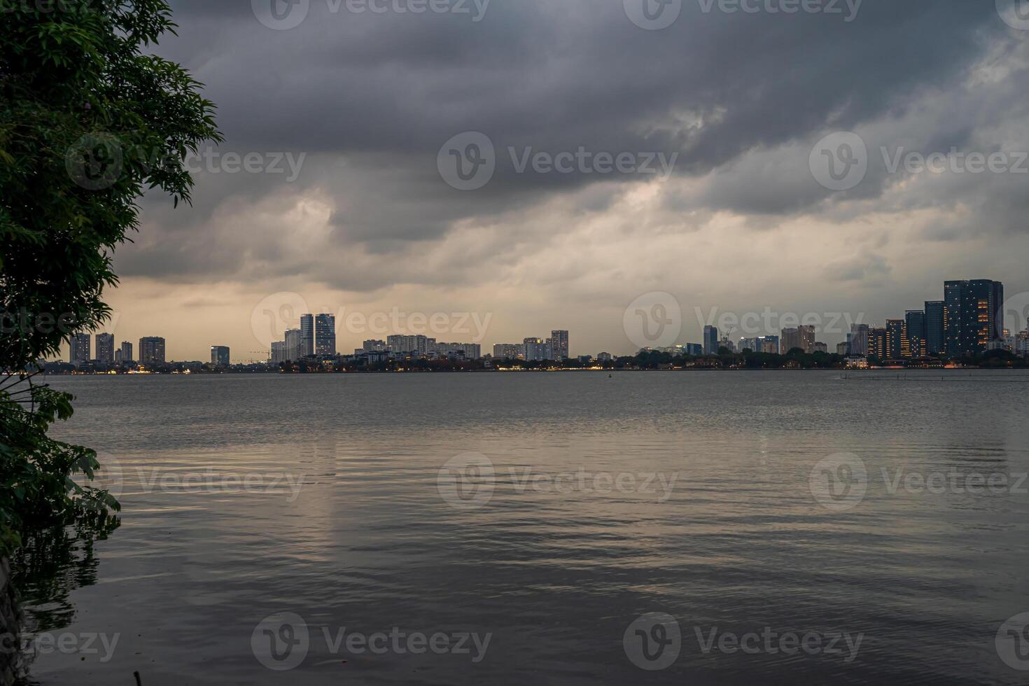 Hanoi, Vietnam - 25 Jun 2024 West Lake in Hanoi in the dark cloudy evening. Ha Noi cityscape. Travel concept photo