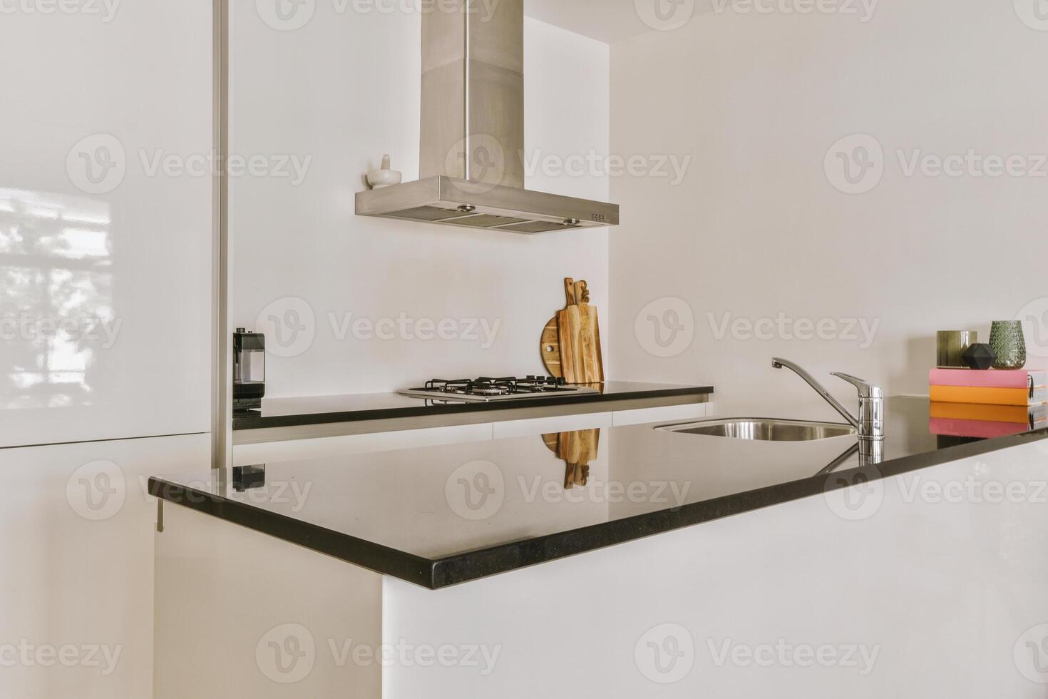 A kitchen with a sink and a stove top photo