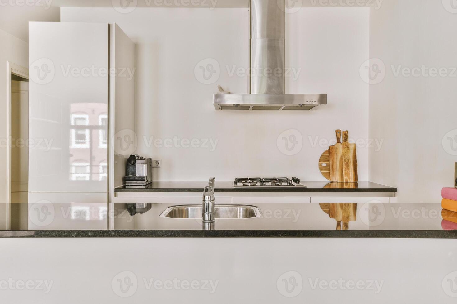 A kitchen with a sink and a stove photo