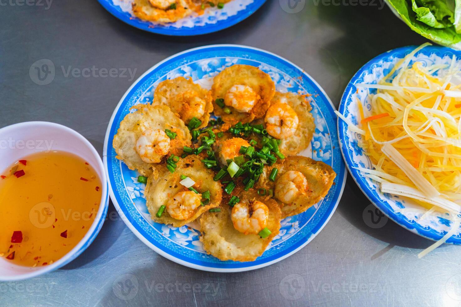 Vietnamese tiny shrimp pancake- Banh Khot Vung Tau. Vietnamese local cuisine. Served with vegetables. Selective focus photo