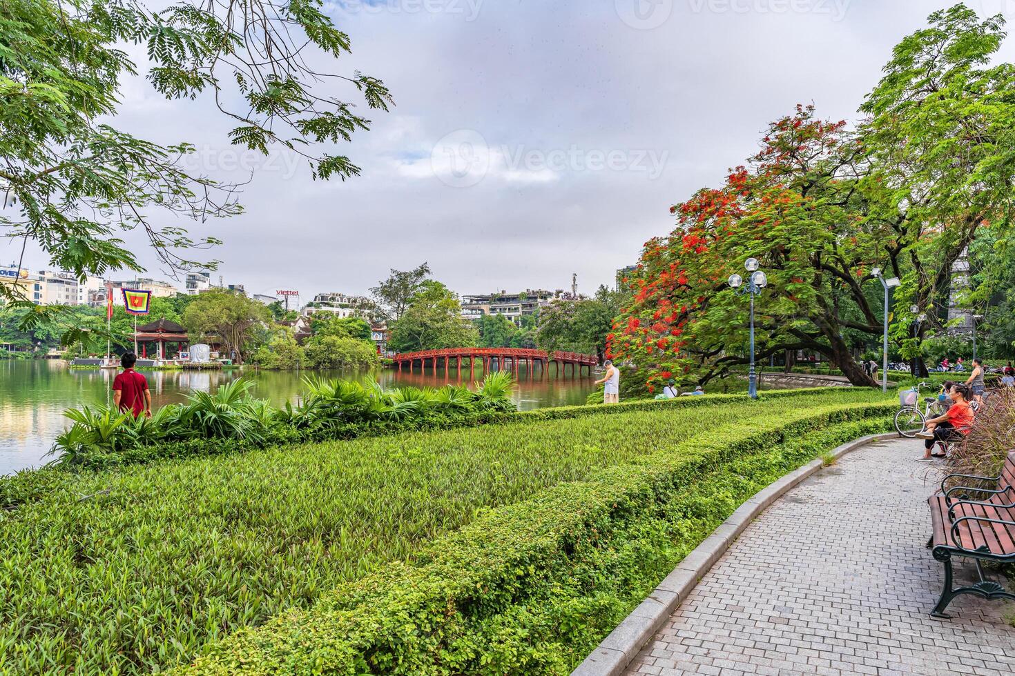 Hanoi, Vietnam - 26 June 2024 Red The Huc Bridge and Ngoc Son Temple in the center of Hoan Kiem Lake, Hanoi, Vietnam. Famous destination of Vietnam photo
