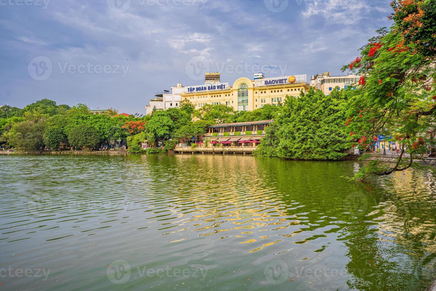 Hanoi, Vietnam - 26 June 2024 Hoan Kiem lake or Sword lake, Ho Guom in Hanoi, Vietnam with Turtle Tower, on clear day with blue sky and white clouds photo
