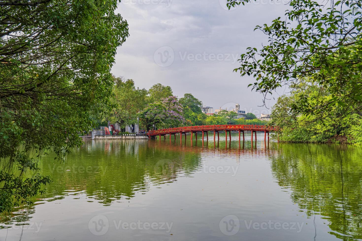 Hanoi, Vietnam - 26 June 2024 Red The Huc Bridge and Ngoc Son Temple in the center of Hoan Kiem Lake, Hanoi, Vietnam. Famous destination of Vietnam photo