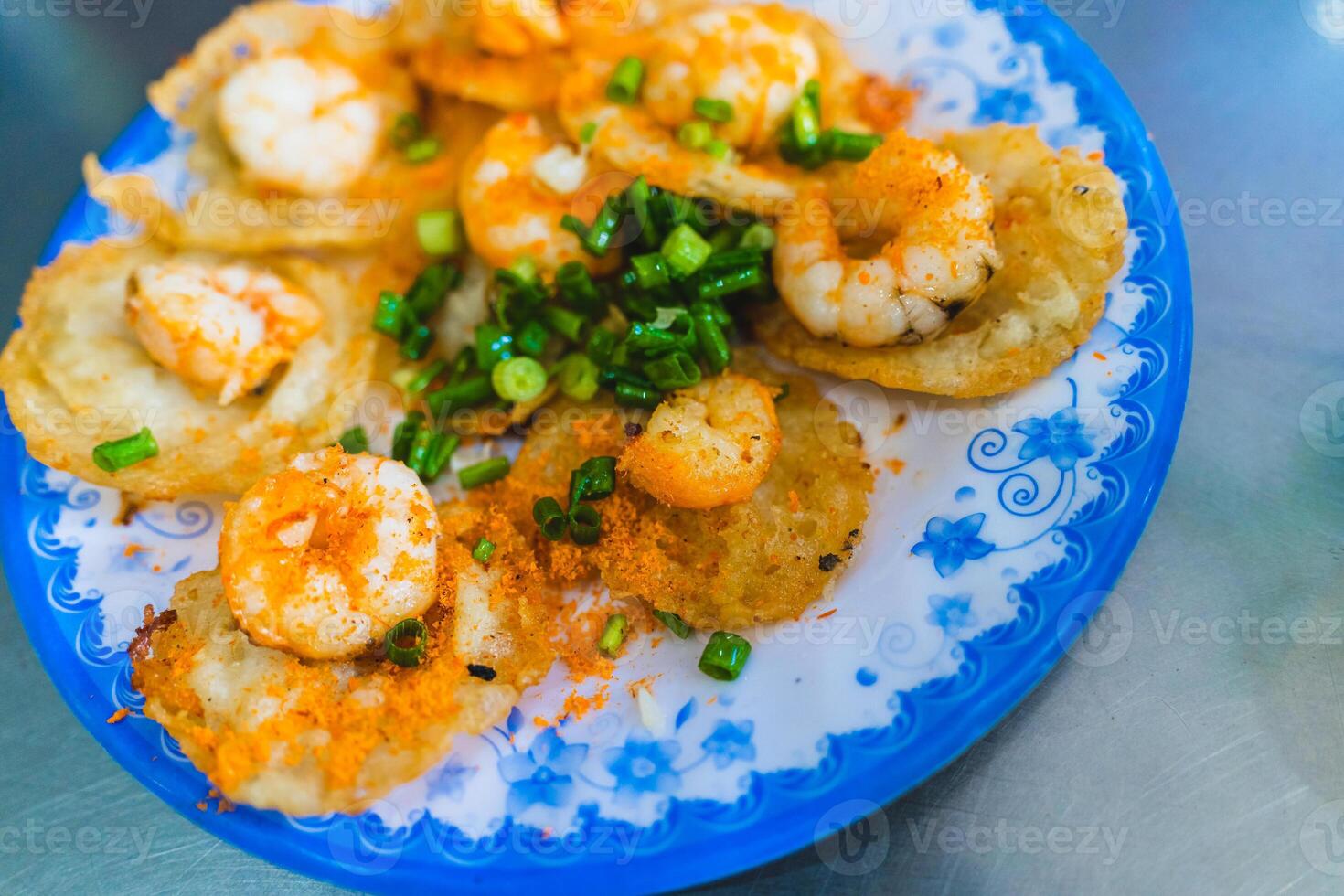 Vietnamese tiny shrimp pancake- Banh Khot Vung Tau. Vietnamese local cuisine. Served with vegetables. Selective focus photo