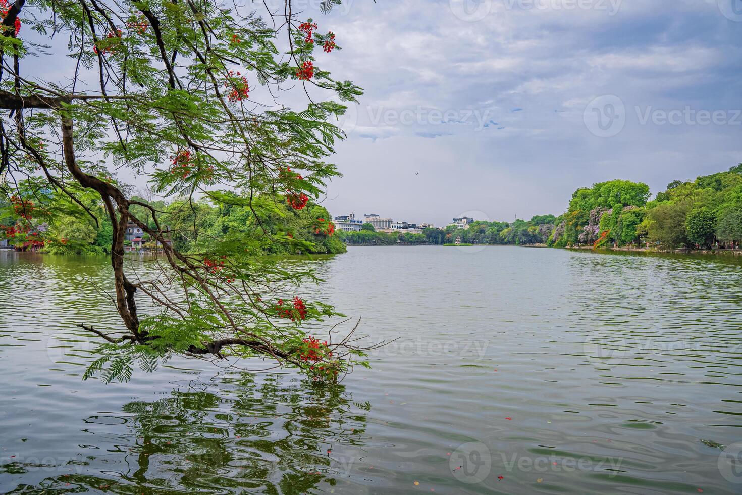 Hanoi, Vietnam - 26 June 2024 Hoan Kiem lake or Sword lake, Ho Guom in Hanoi, Vietnam with Turtle Tower, on clear day with blue sky and white clouds photo