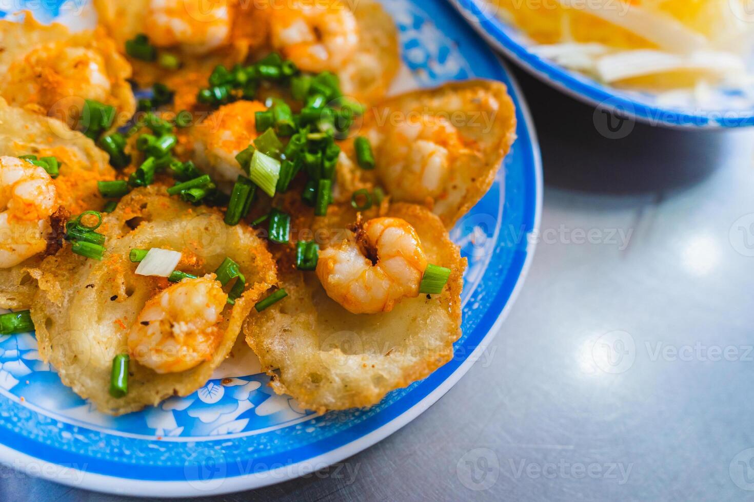 Vietnamese tiny shrimp pancake- Banh Khot Vung Tau. Vietnamese local cuisine. Served with vegetables. Selective focus photo