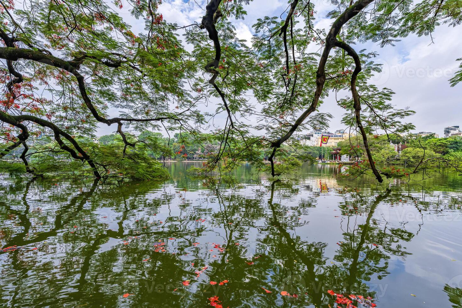 Hanoi, Vietnam - 26 June 2024 Hoan Kiem lake or Sword lake, Ho Guom in Hanoi, Vietnam with Turtle Tower, on clear day with blue sky and white clouds photo