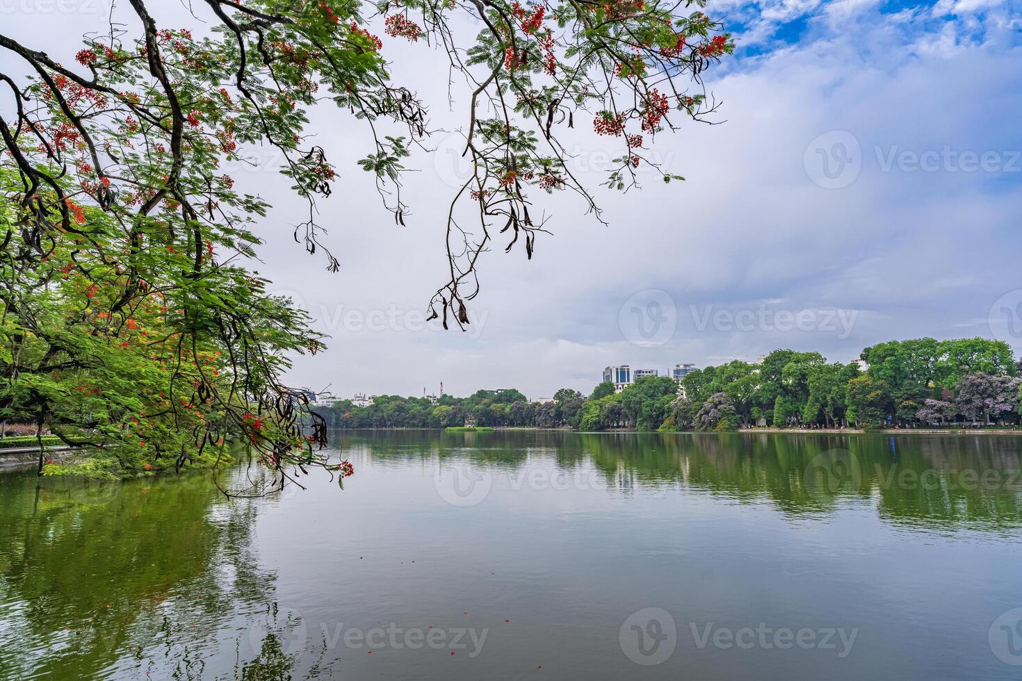 Hanoi, Vietnam - 26 June 2024 Hoan Kiem lake or Sword lake, Ho Guom in Hanoi, Vietnam with Turtle Tower, on clear day with blue sky and white clouds photo