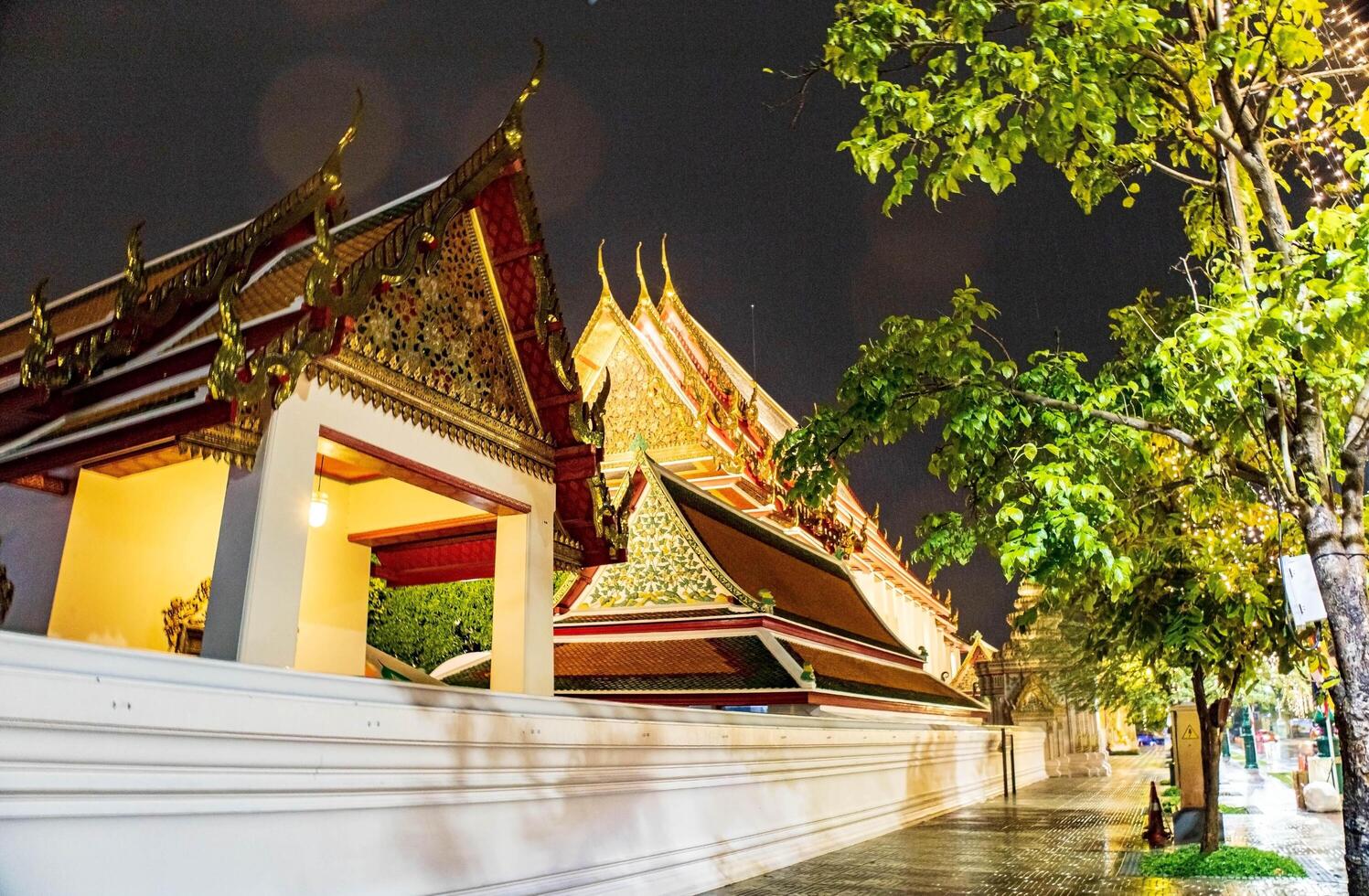 Wat Pho's pagoda-style roof and rich cultural details at night sky, evoking a sense of history and spirituality, Bangkok, Thailand. photo