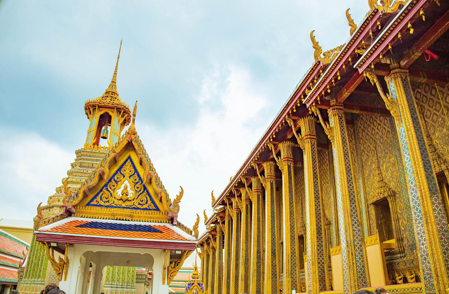 A golden Thai temple roof in Bangkok, showcasing intricate architecture and traditional, Wat Phra Kaew, Thailand. photo