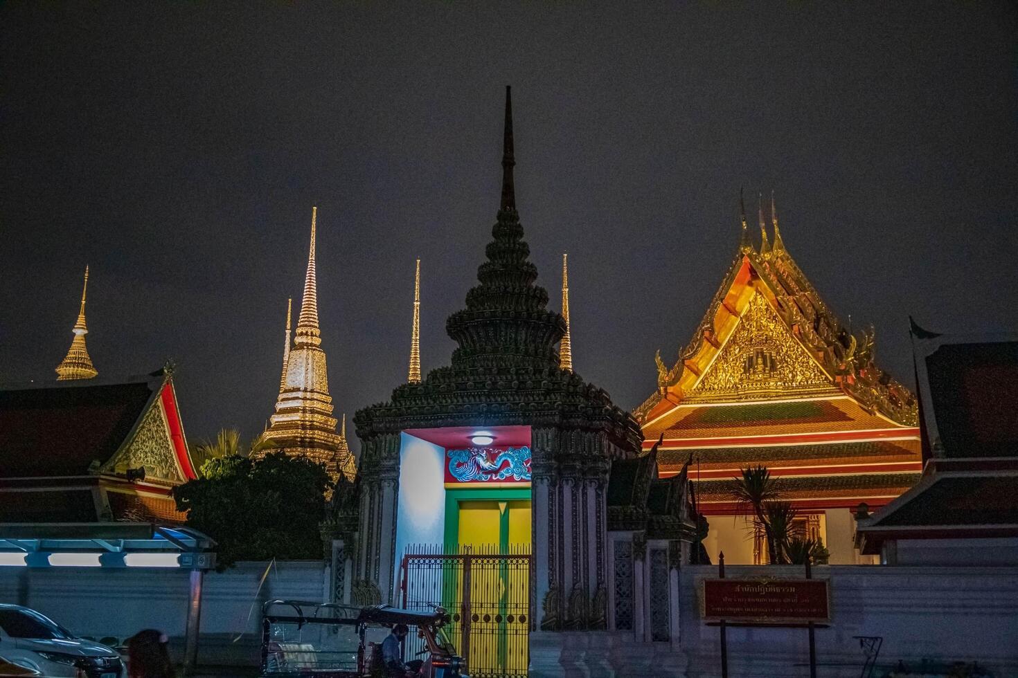 Wat Pho's pagoda-style roof and rich cultural details at night sky, evoking a spirituality, Bangkok, Thailand. photo