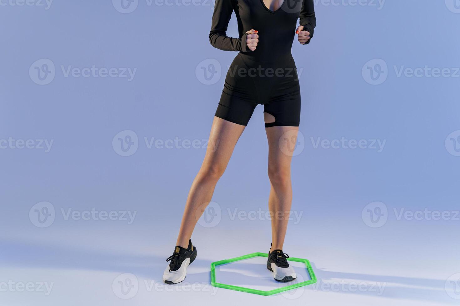 Close up of woman doing cardio training using special professional equipment on studio background photo