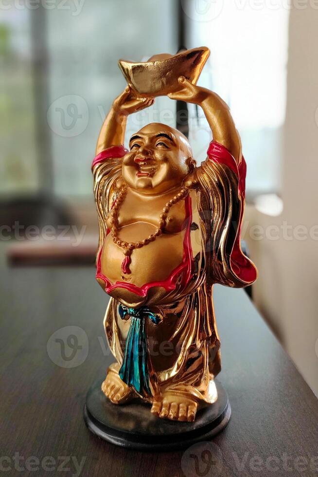 Laughing Buddha also known as Fat Buddha. Budai also known as Hotei or Pu Tai is a semi-historical Chinese monk who is venerated as a deity in Chinese Buddhism. photo
