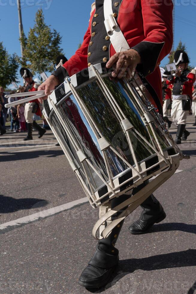 A big beautiful drum. A drummer beats a drum marching down the street, close-up photo. photo