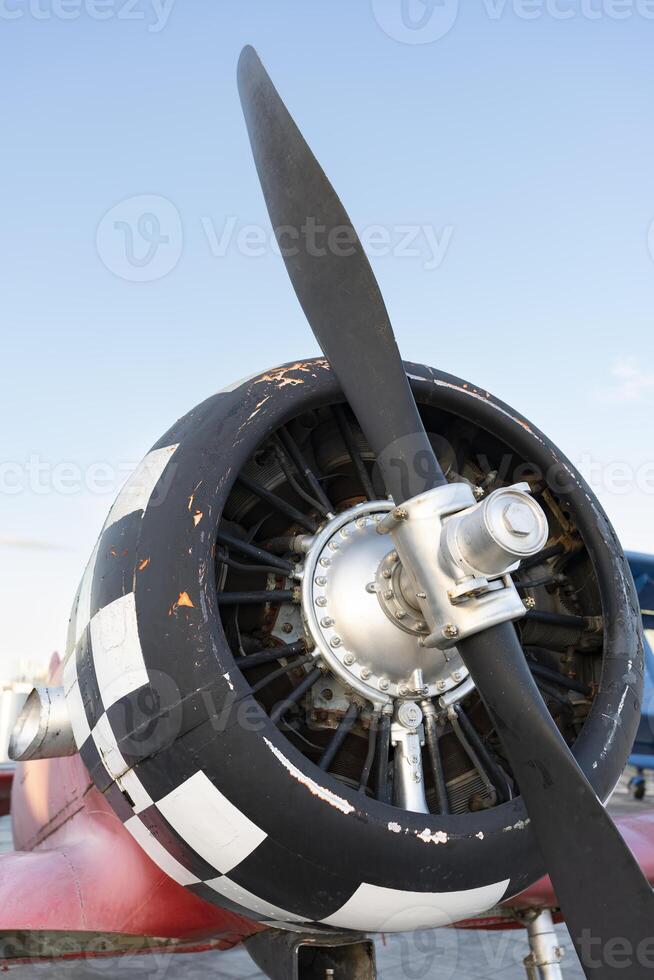Engine of an old plane. Propeller of an historical aircraft. Model of steel ancient fight airplane. photo