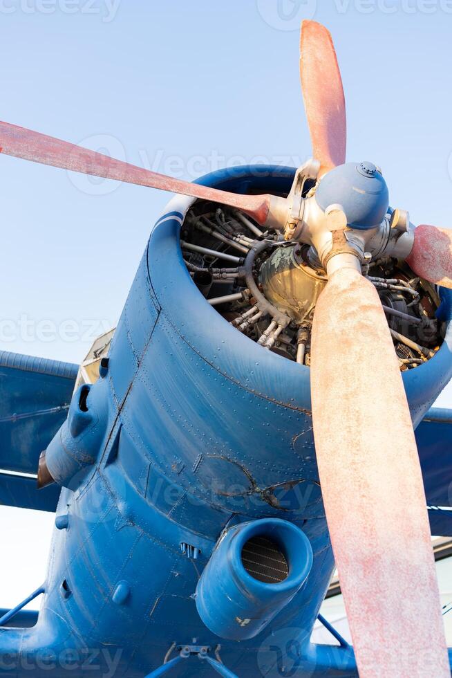 Engine of an old plane. Plane with propeller on beautiful bright sky background. photo