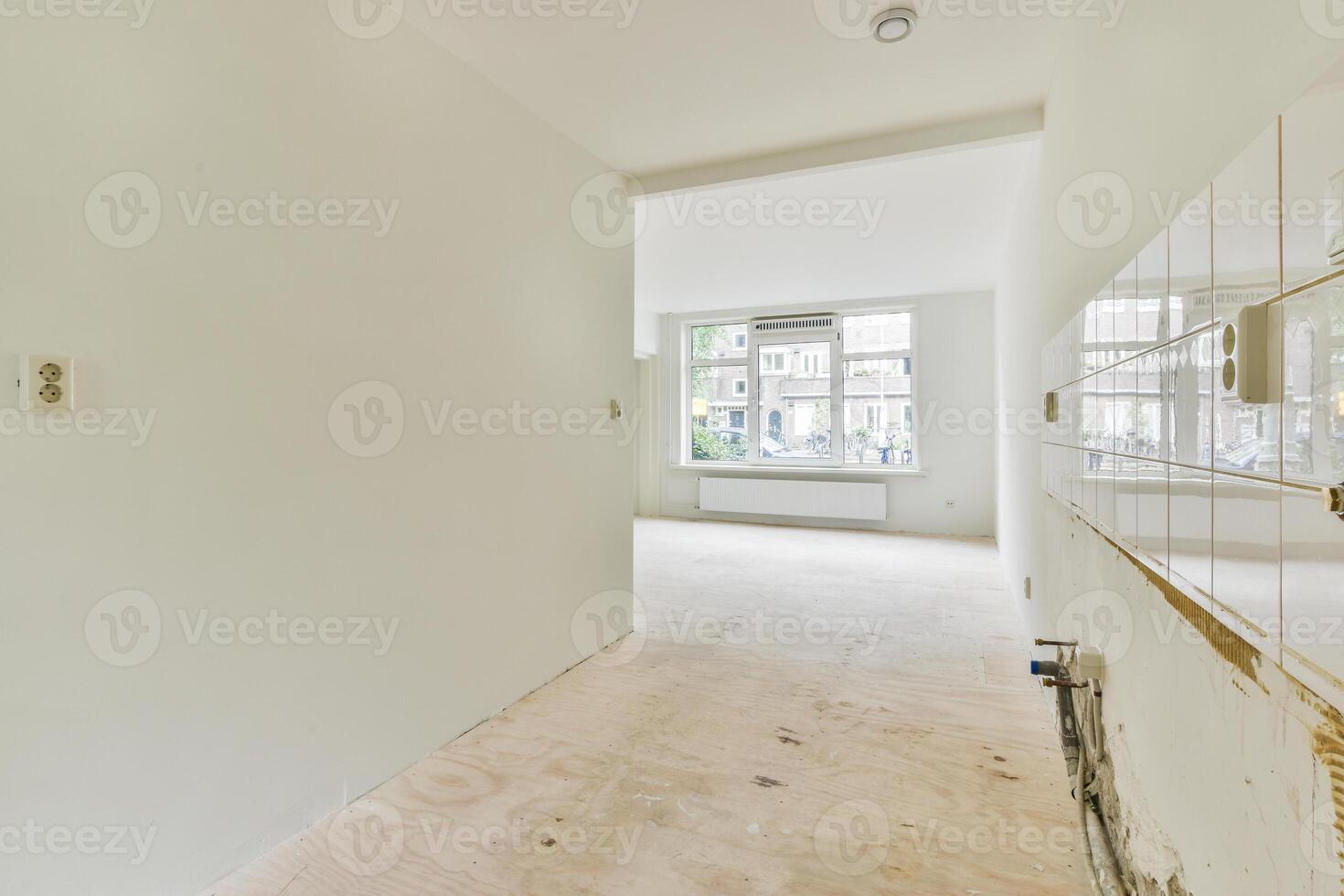 A white hallway with a door and a window photo