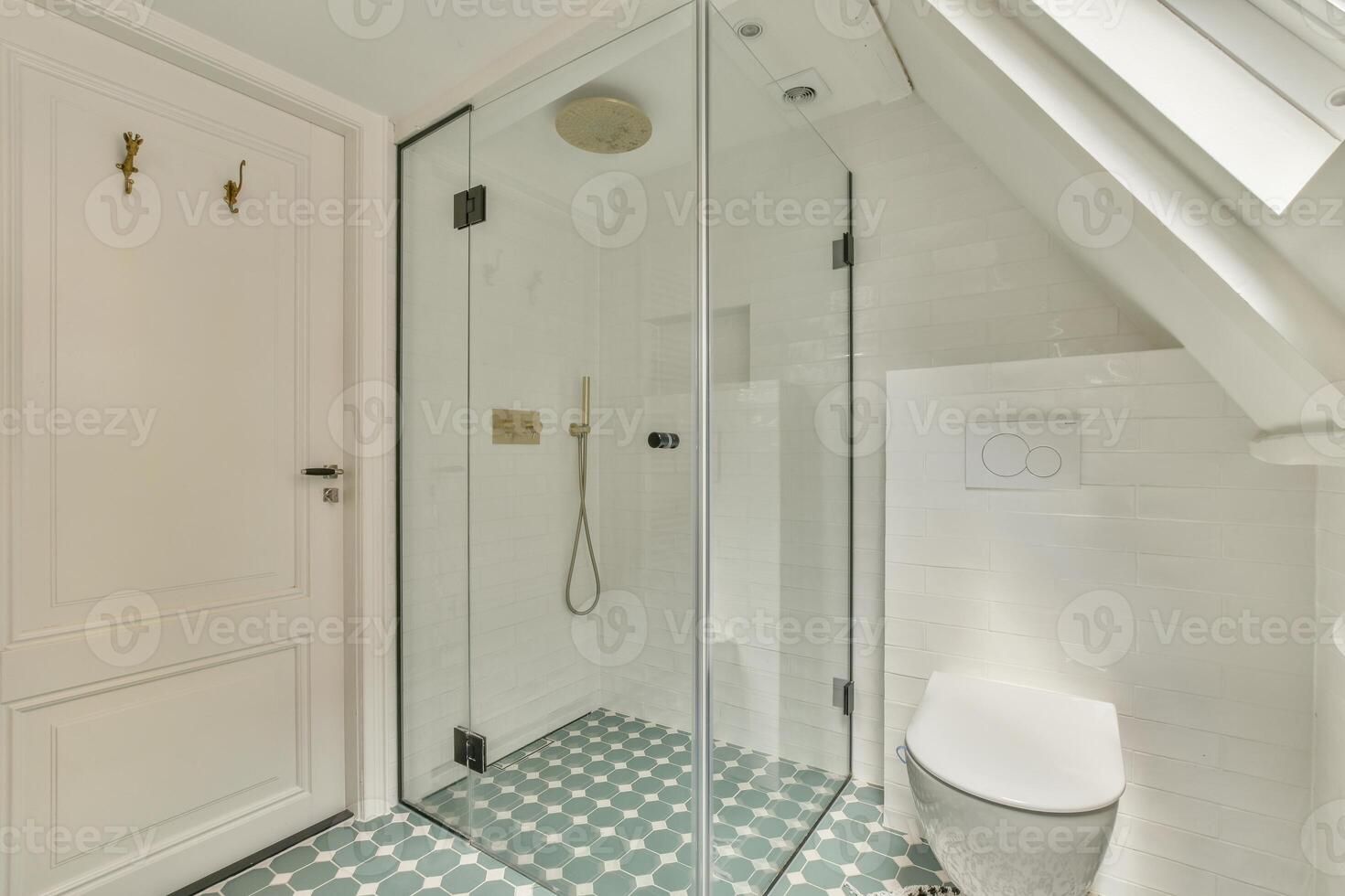 A bathroom with a glass shower and toilet photo
