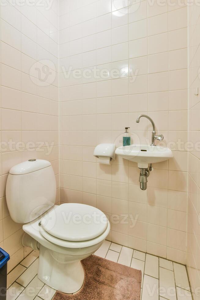 A white toilet sitting in a bathroom photo