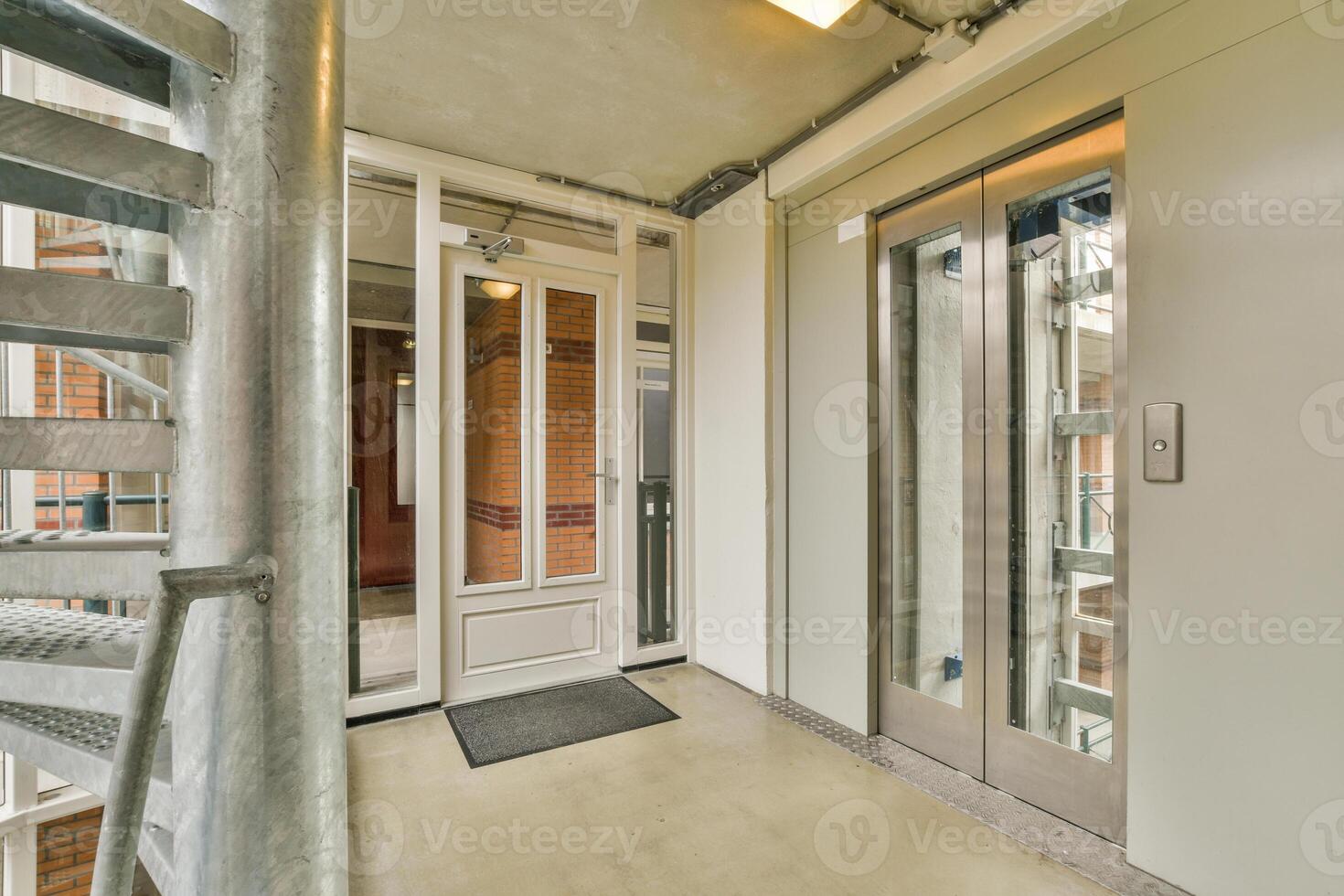 An elevator in a building with a spiral staircase photo