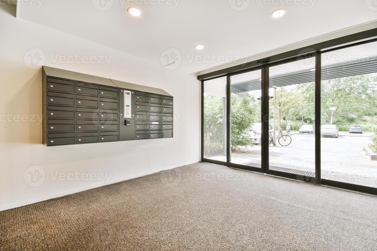An empty office with a large glass door and a mailbox photo
