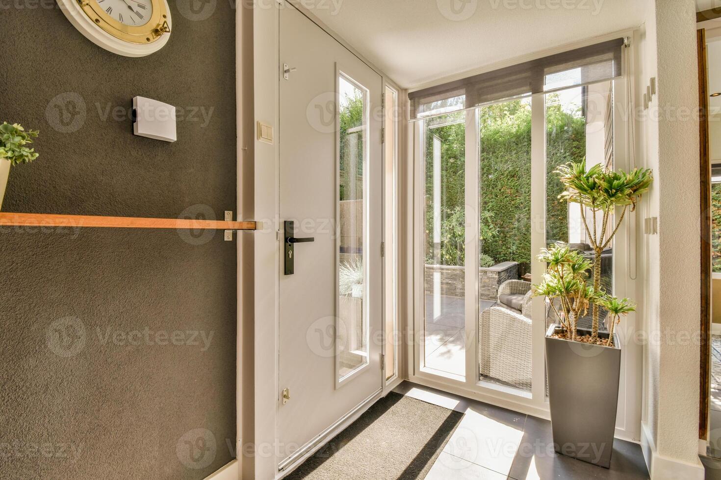 A hallway with a door and a clock on the wall photo
