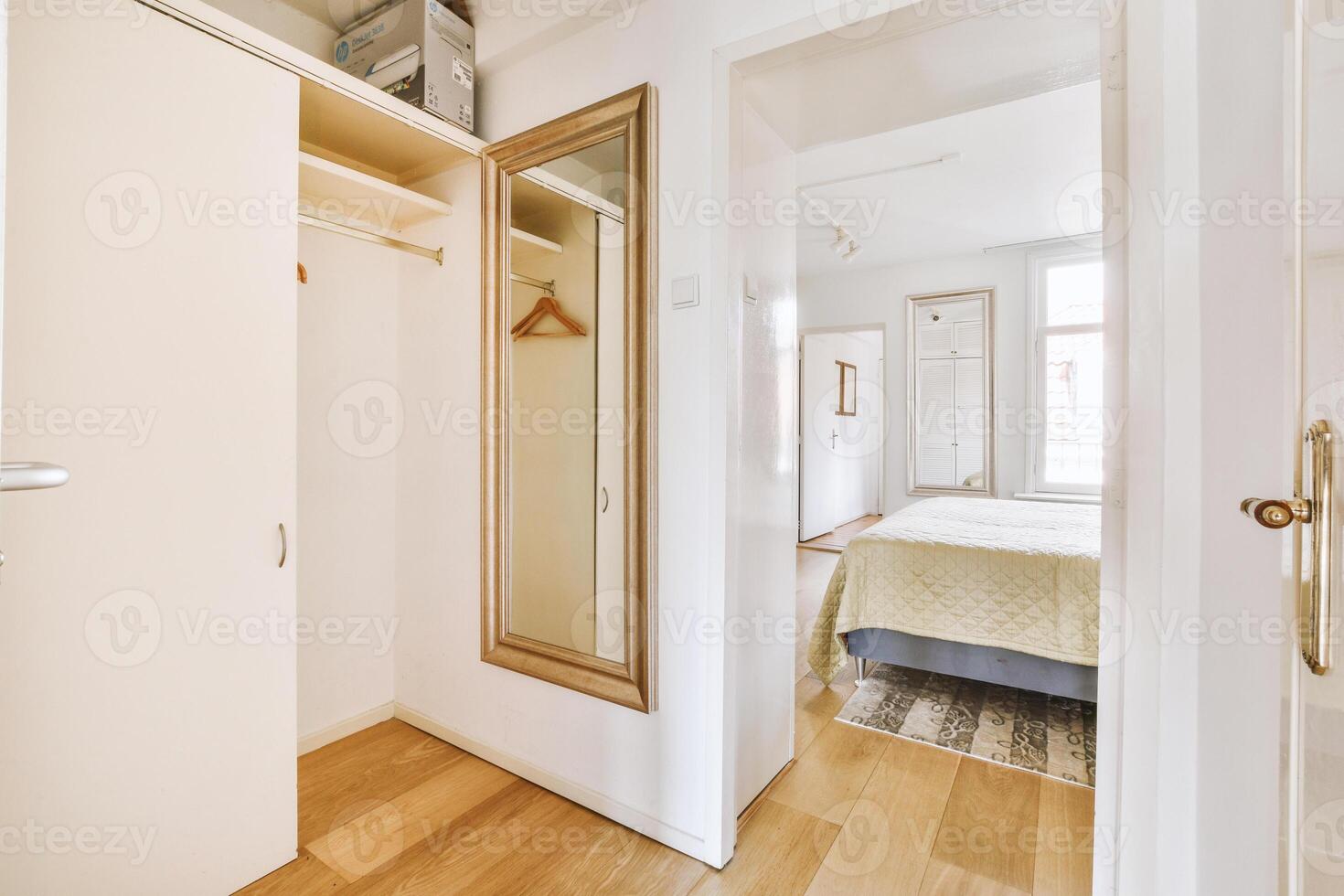 A bedroom with a bed, closet and mirror photo