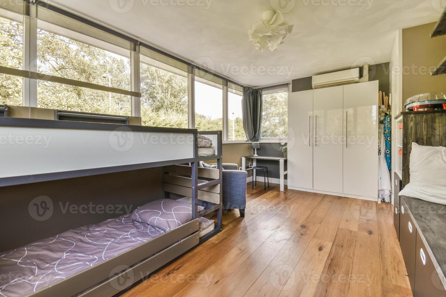A bedroom with bunk beds and a window photo