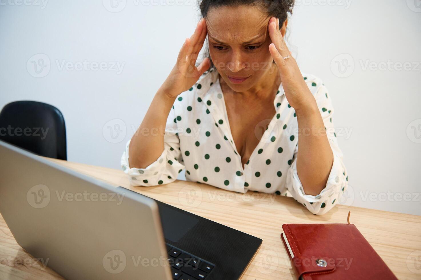 Stressed woman at work facing computer issues, feeling frustrated and overwhelmed in office setting photo