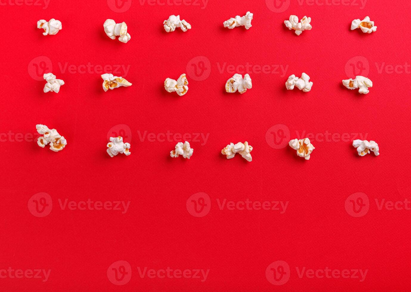 popcorn macro on a red background photo