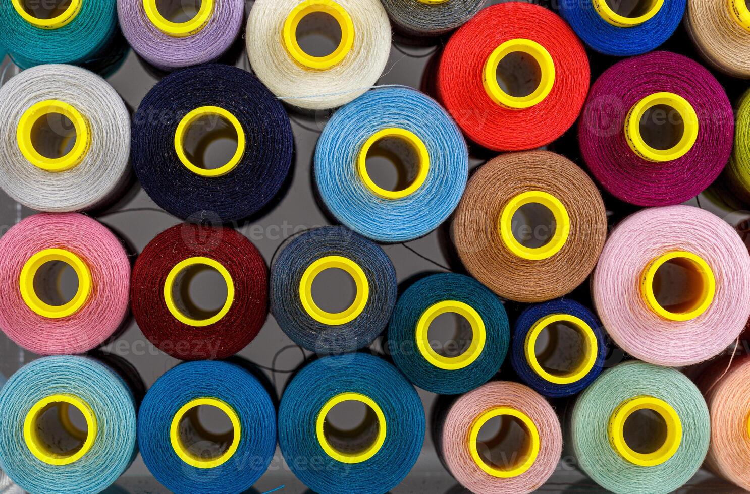 set of multi-colored spools of thread for sewing photo