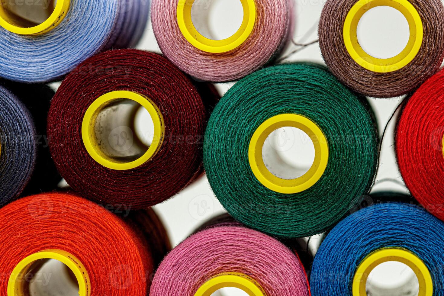 set of multi-colored spools of thread for sewing photo