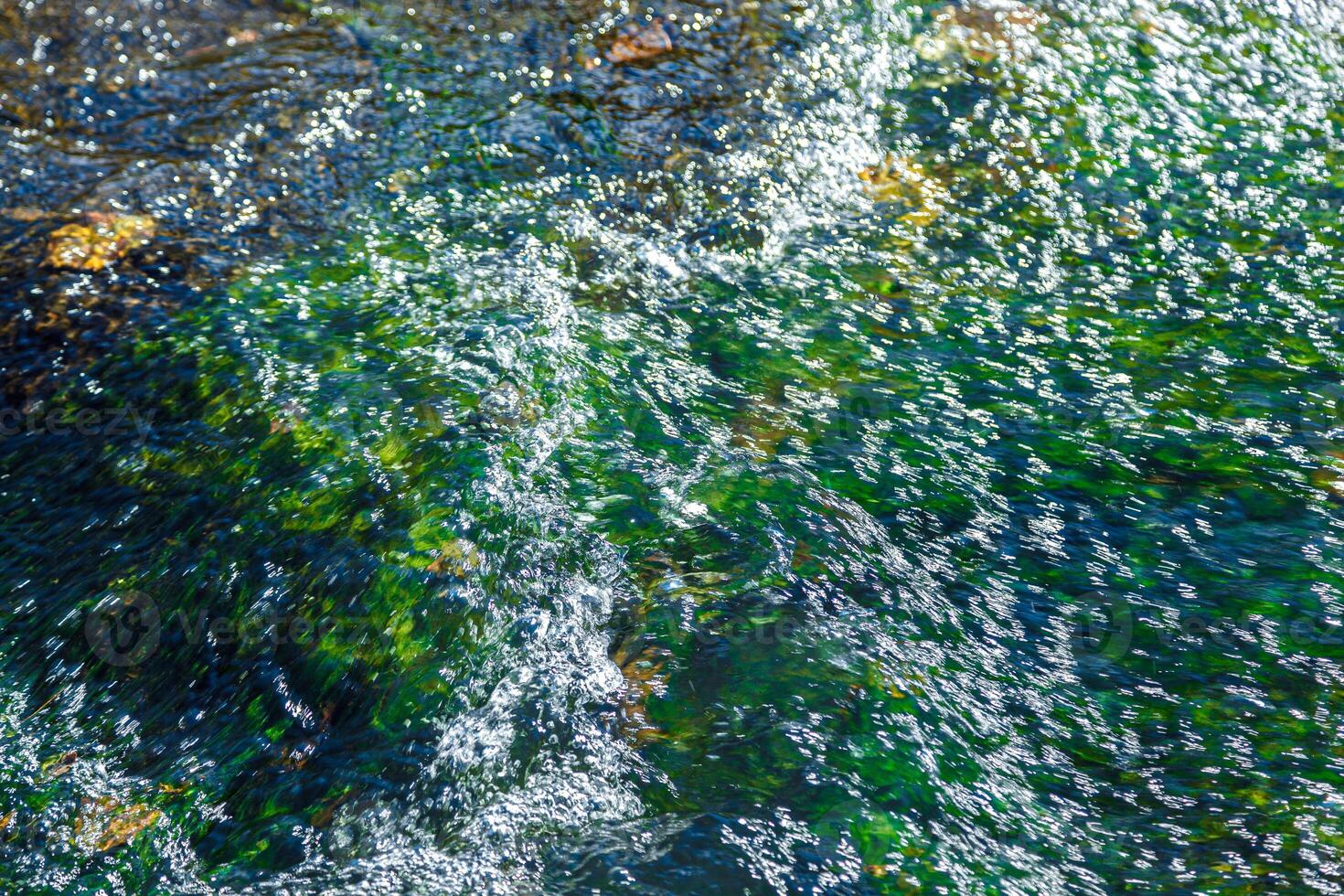 flow of water and spray from a stone photo