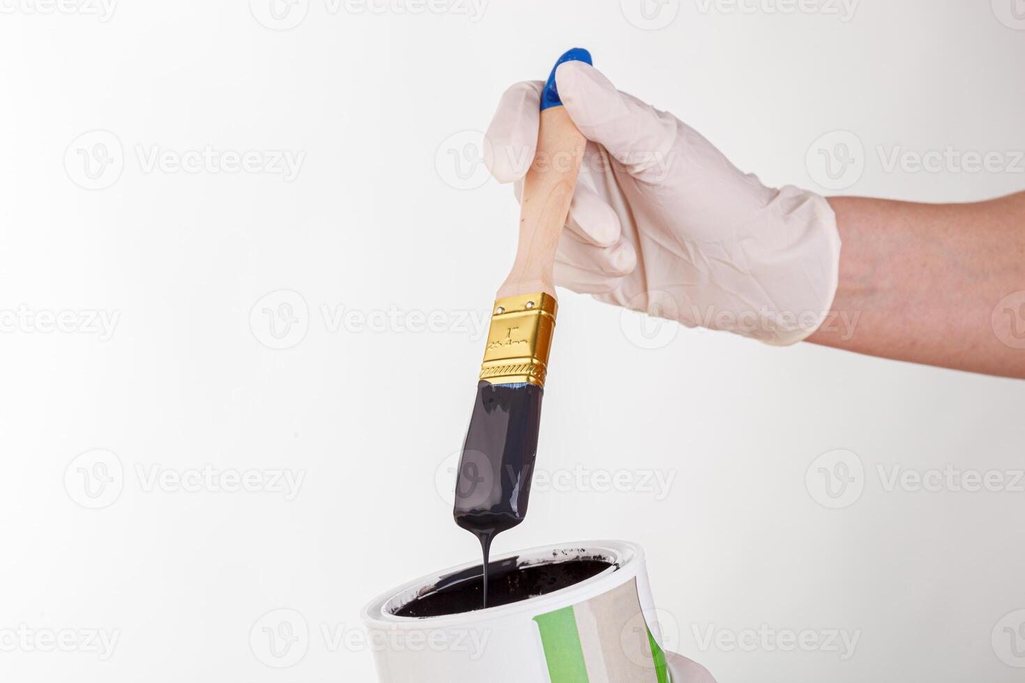 hand with a brush and a can of paint on a white background photo