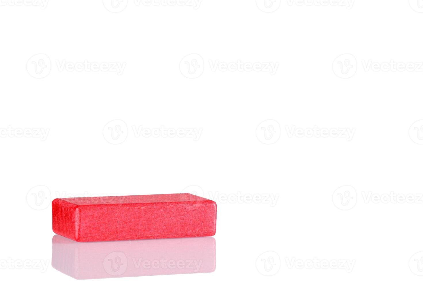 Wooden cube of red color on a white background photo