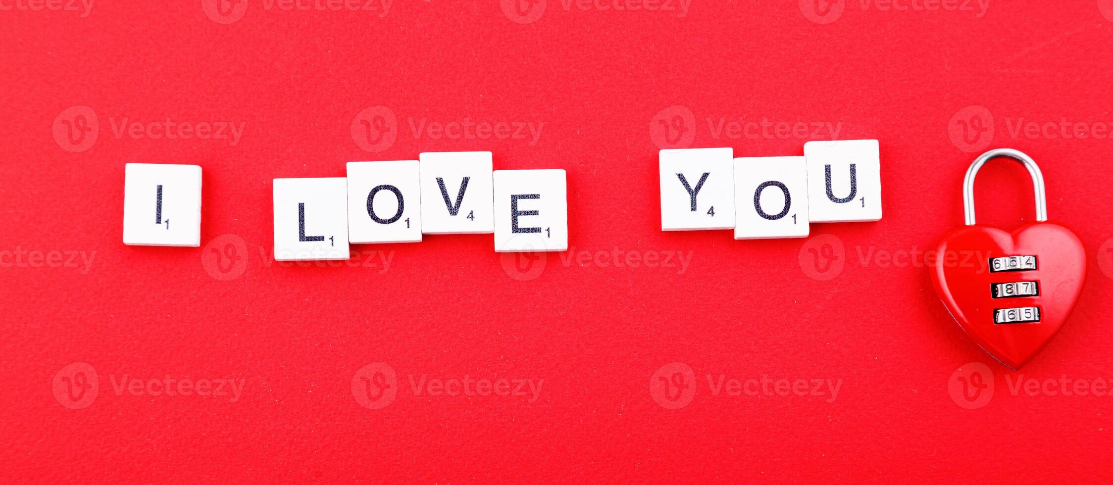 inscription love and red hearts on a red background photo