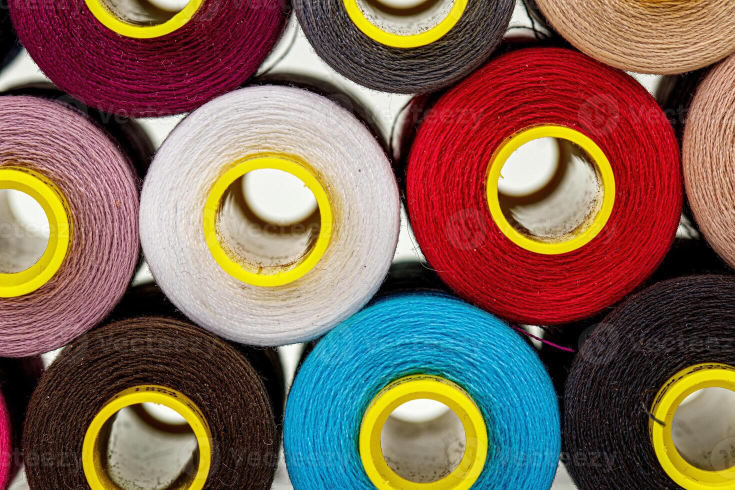 set of multi-colored spools of thread for sewing photo