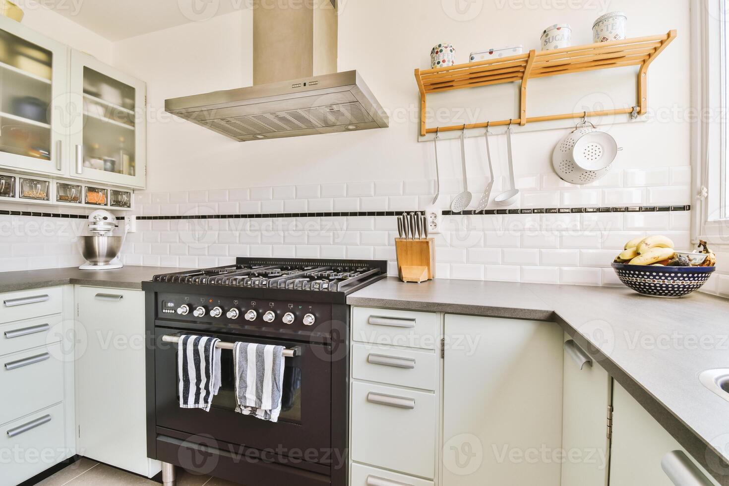 A kitchen with a stove and oven photo
