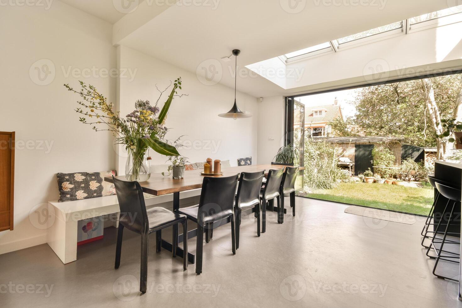 A modern kitchen with a dining table and chairs photo